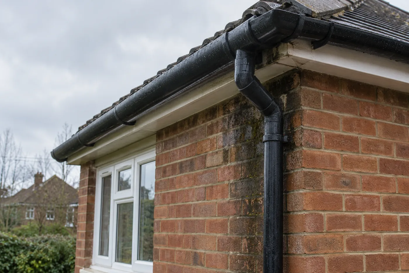 Illustrative image of rainwater guttering and brickwork