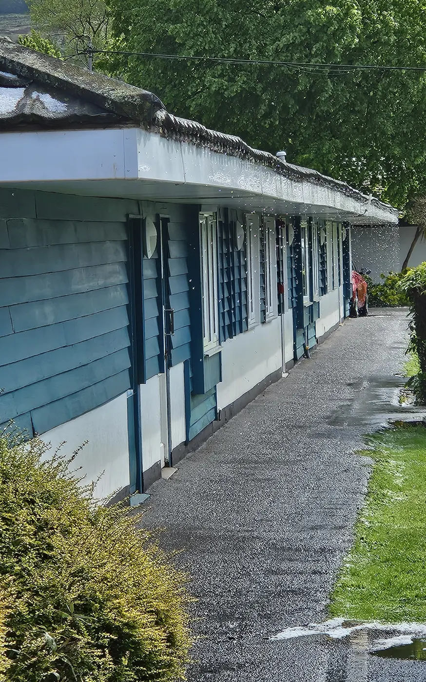Rainwater dripping from a gutter